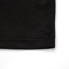 Close-up of a black textured fabric corner on a white background
