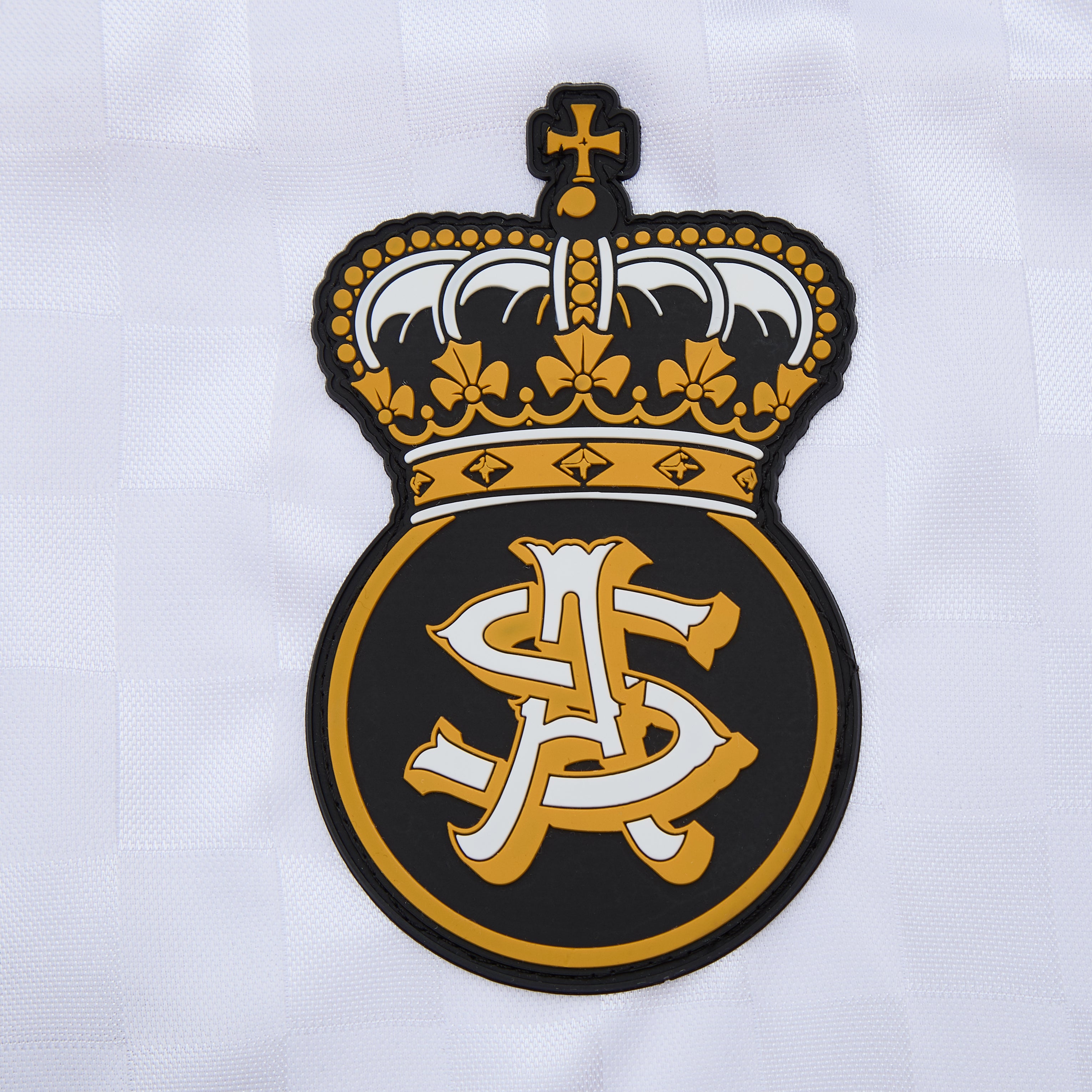 Embroidered logo with a crown on a white background