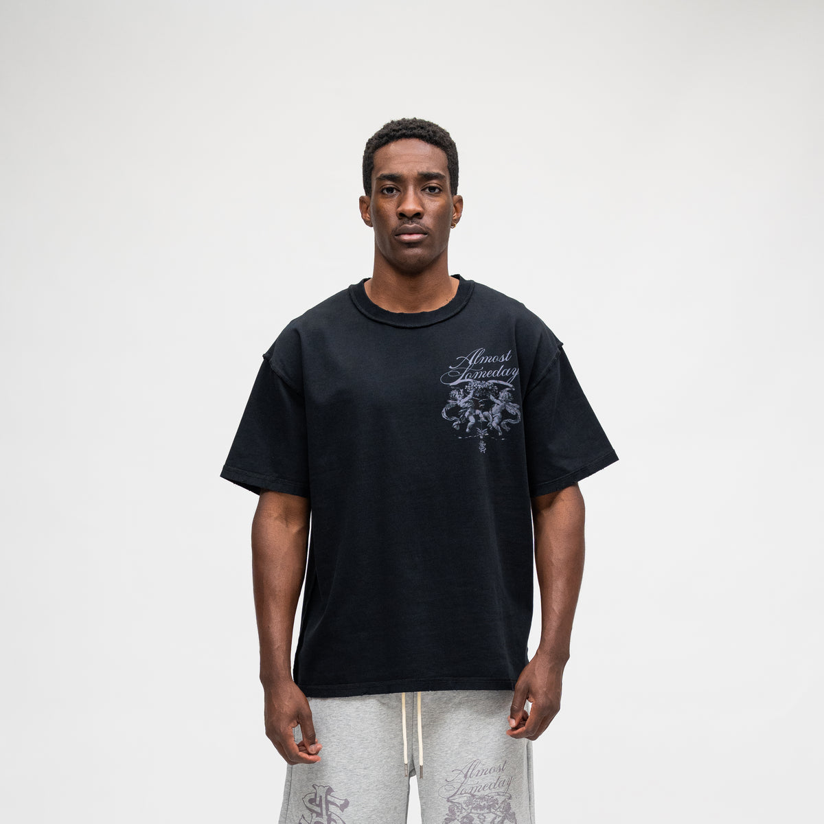 ALMOST SOMEDAY Flourish Tee in Black, front view