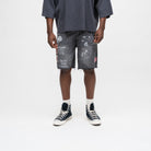 ALMOST SOMEDAY Gallery Denim Jort in Black, front view with allover collage print including dice, lips, and text graphics