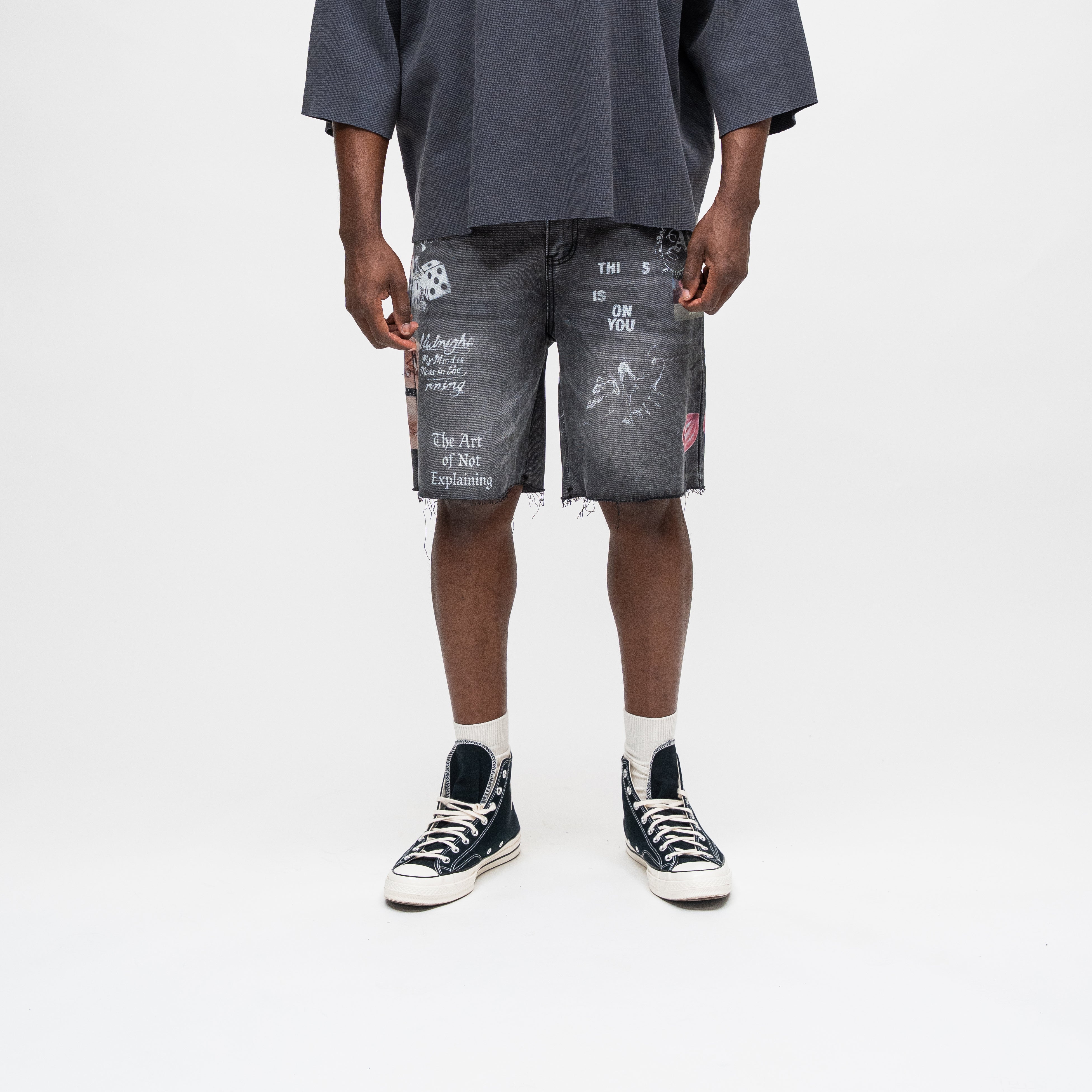ALMOST SOMEDAY Gallery Denim Jort in Black, front view with allover collage print including dice, lips, and text graphics