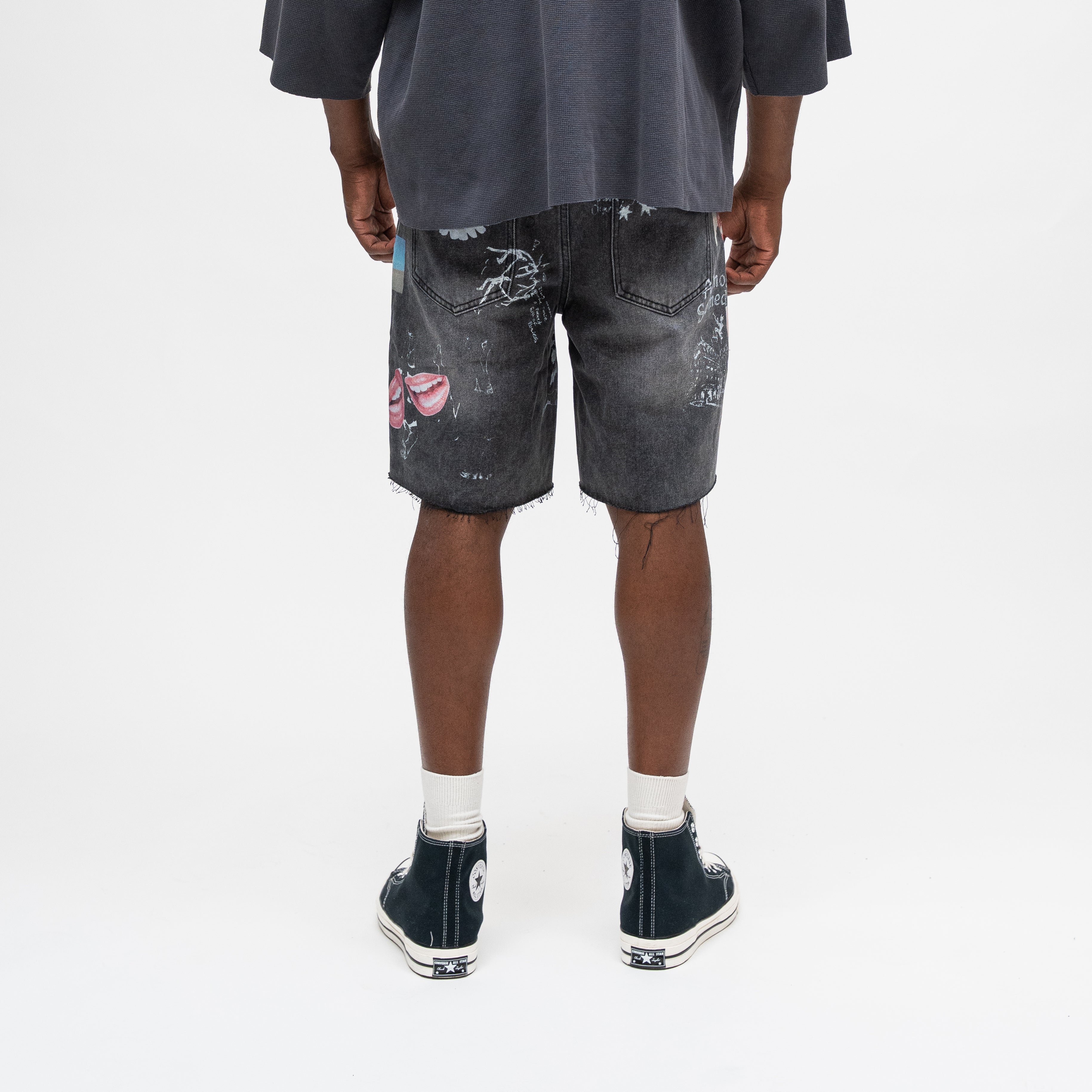 ALMOST SOMEDAY Gallery Denim Jort in Black, back view with allover collage print and raw frayed hem