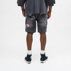 ALMOST SOMEDAY Gallery Denim Jort in Black, back view with allover collage print and raw frayed hem