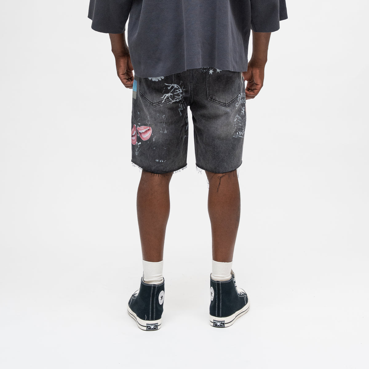 ALMOST SOMEDAY Gallery Denim Jort in Black, back view with allover collage print and raw frayed hem