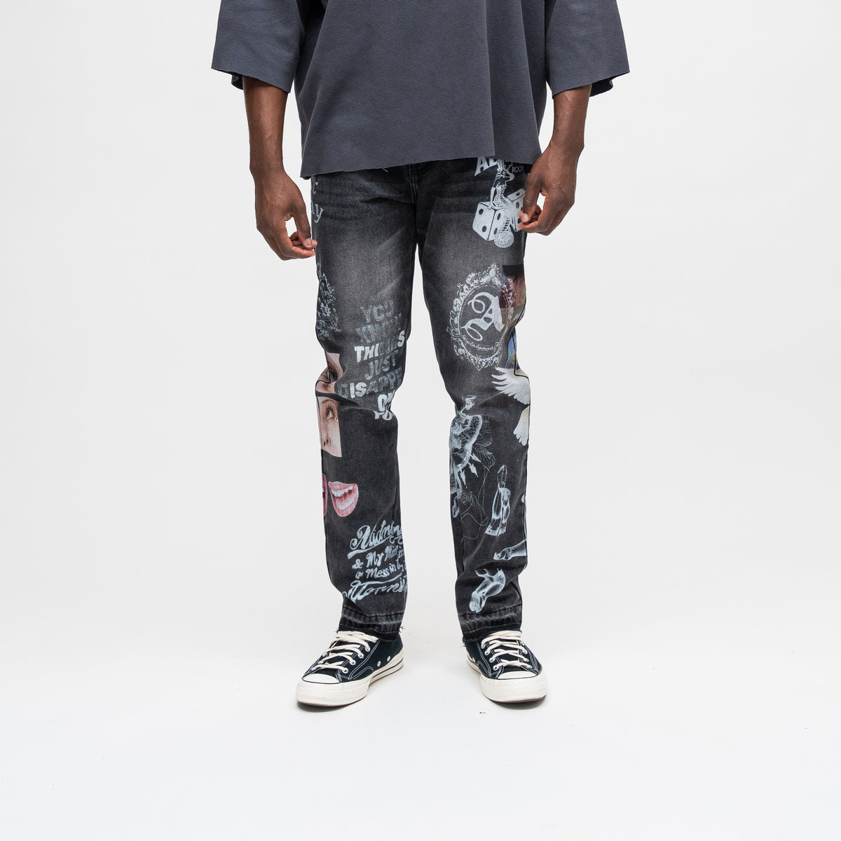 ALMOST SOMEDAY Gallery Denim Pant in Black, front view with allover collage print featuring dice, ornate crest, photo patches, and text graphics