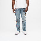 ALMOST SOMEDAY Gallery Denim Pant in Blue Wash, front view with allover collage print including dice, angel figure, and This Is On You text