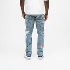 ALMOST SOMEDAY Gallery Denim Pant in Blue Wash, back view with Art of Not Explaining text, angel wings, lips, and architectural illustration