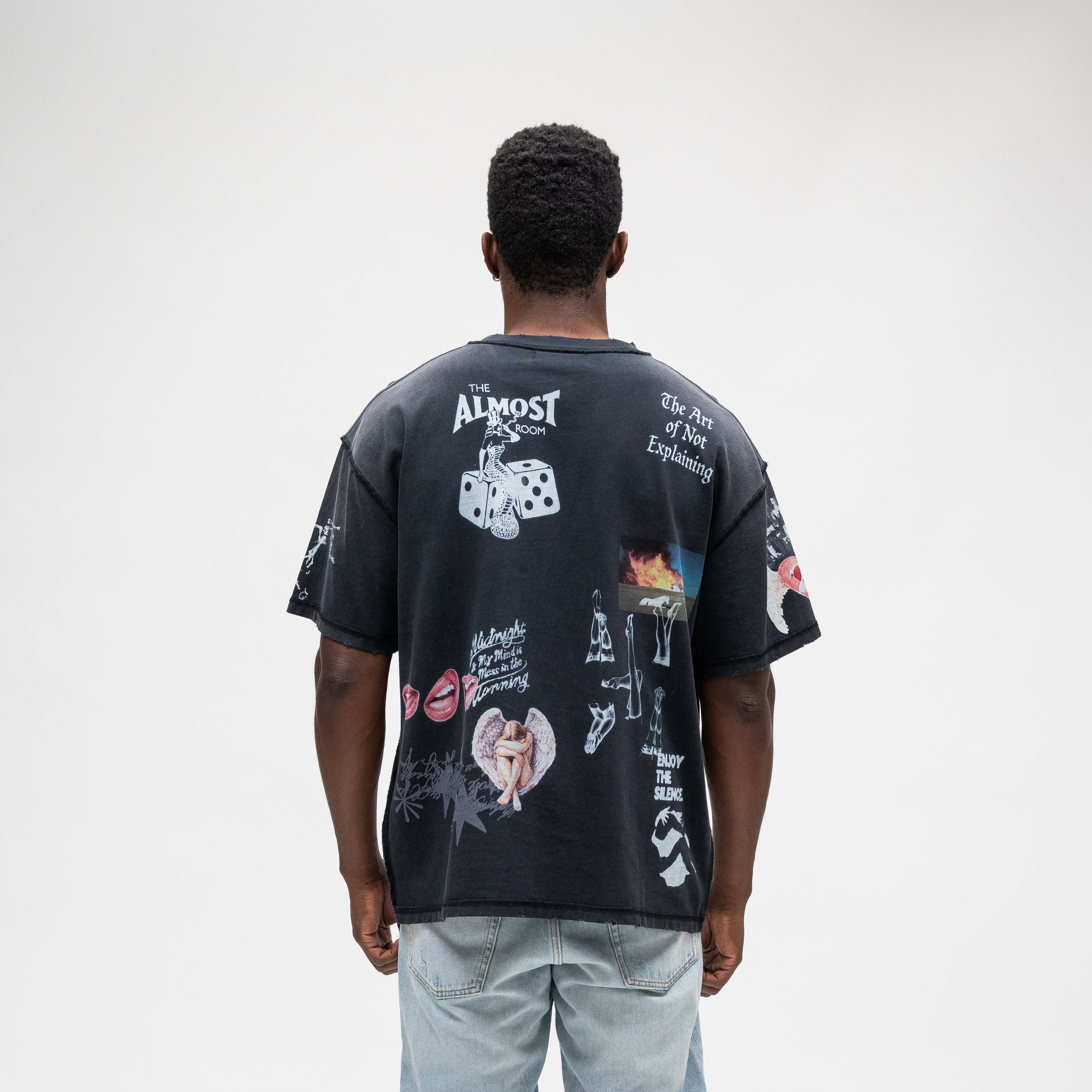 ALMOST SOMEDAY Gallery Tee in Black, back view with The Almost Room, Art of Not Explaining, and Enjoy The Silence text graphics