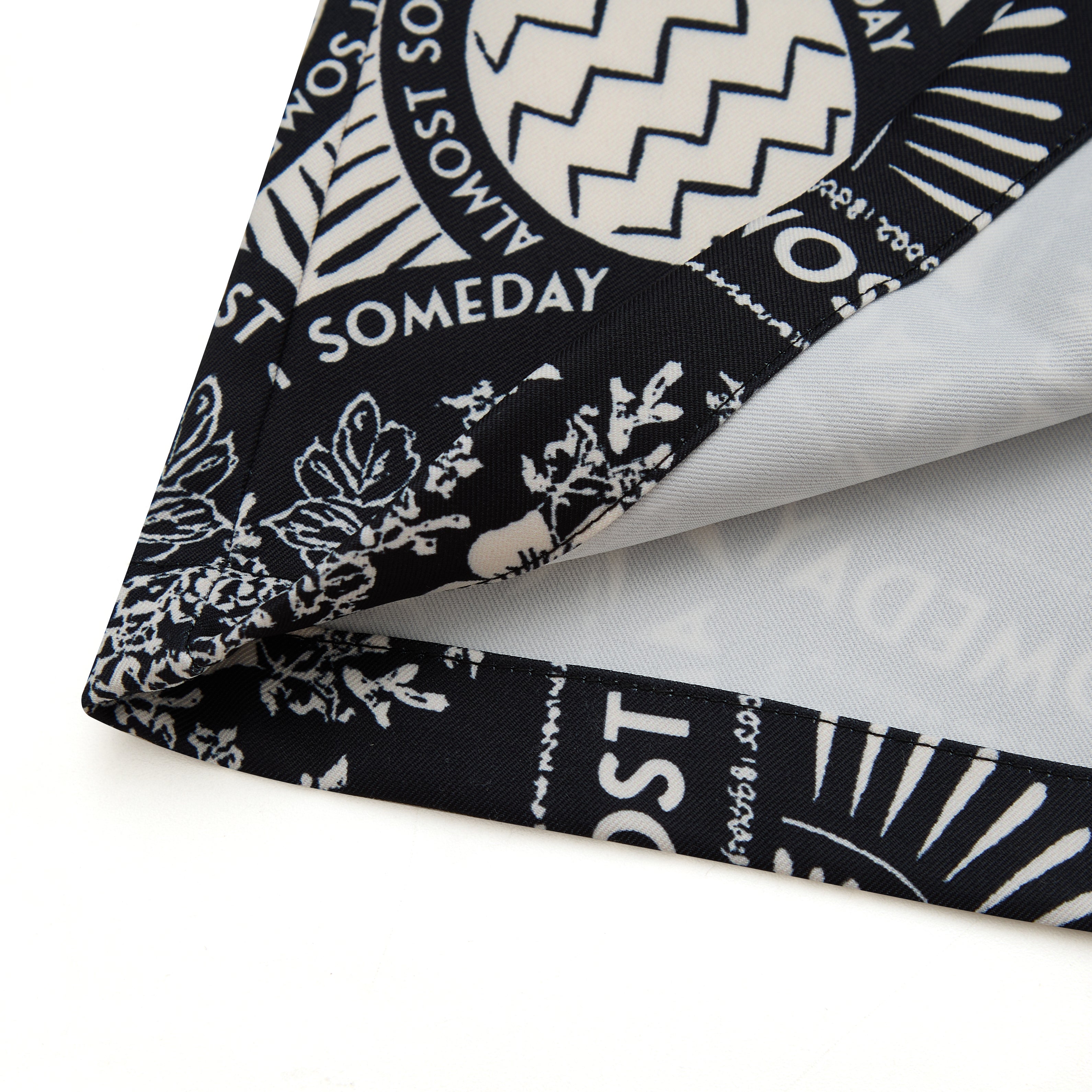 Black and white patterned fabric with text on a white background