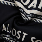 Close-up of black fabric with white text pattern