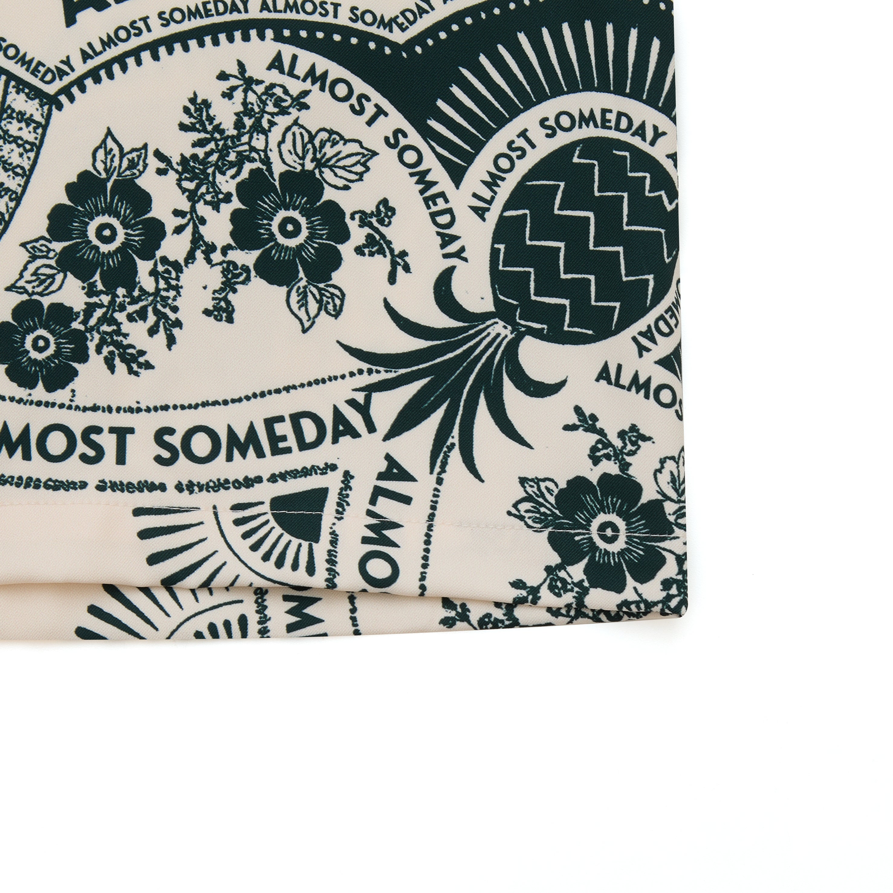 Fabric with 'Almost Someday' text and floral patterns on a white background