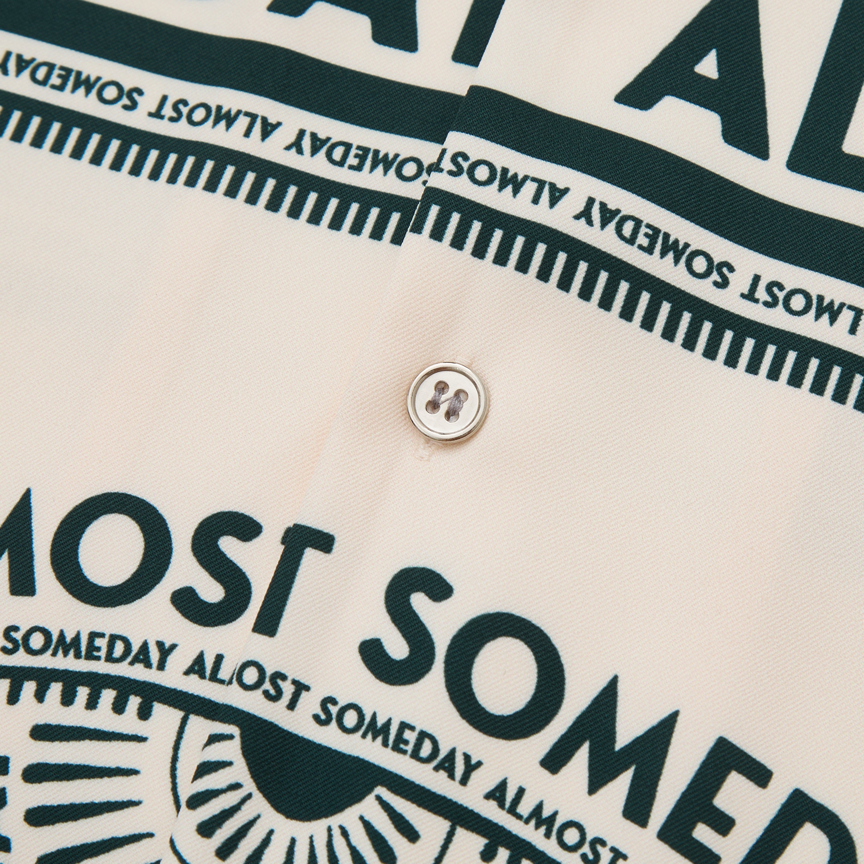 Close-up of a shirt with text and button detail
