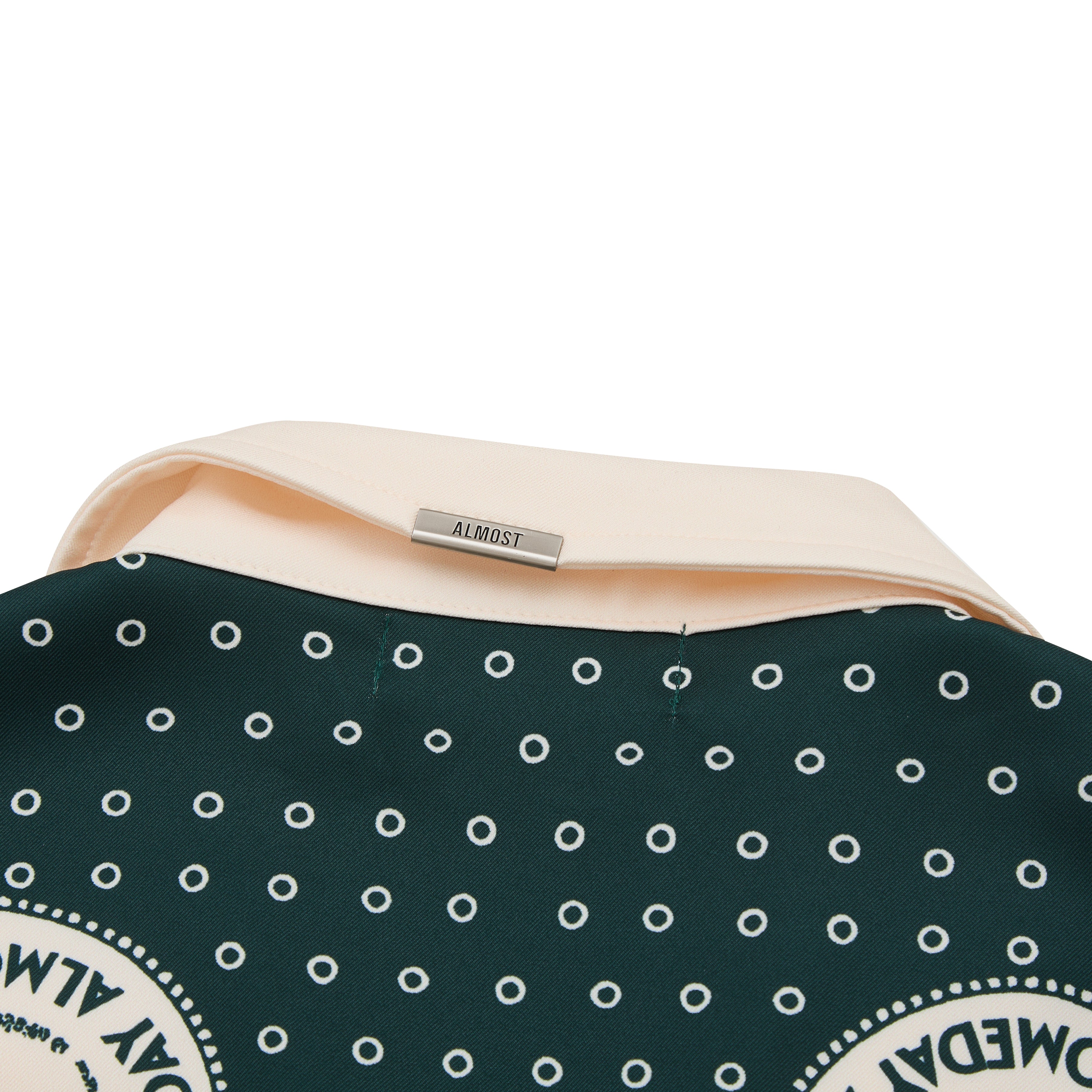 Polka dot short with 'ALMOST' metal detailing on a white background