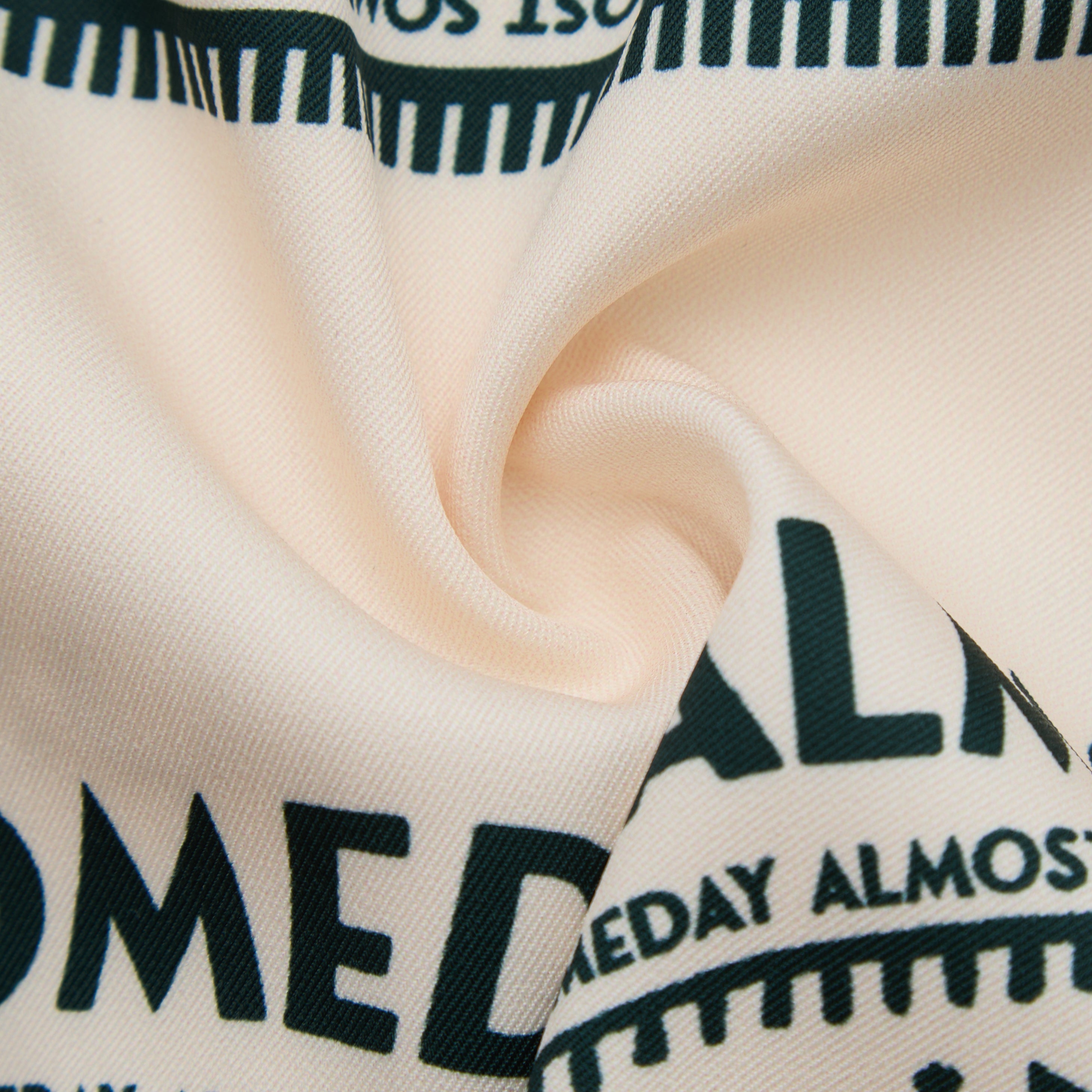 Close-up of beige fabric with black text and stripes