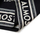 Black fabric with white text pattern on a white background