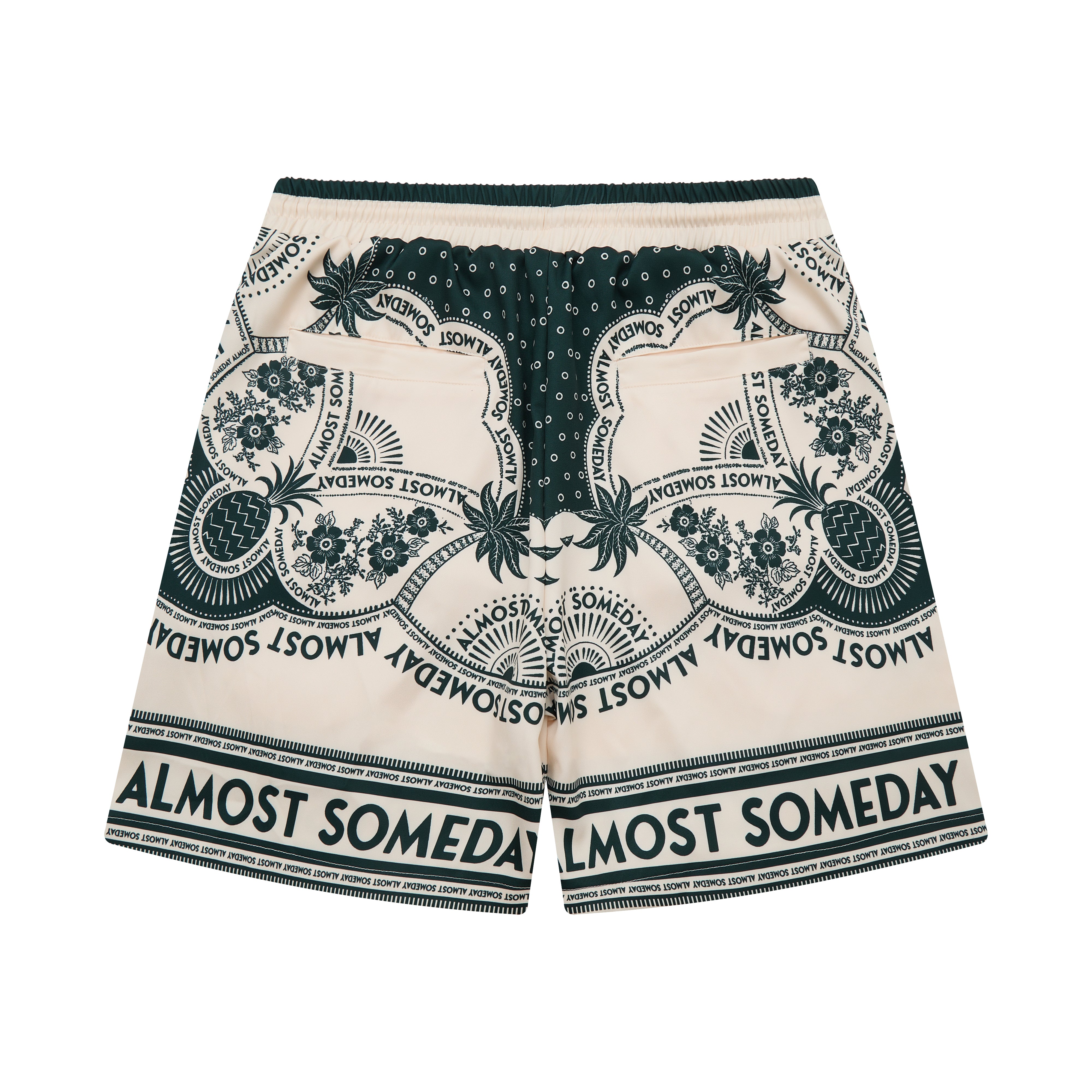 Beige shorts with green floral patterns and 'Almost Someday' text on a white background