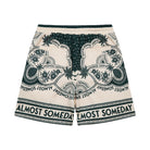 Beige shorts with green floral patterns and 'Almost Someday' text on a white background