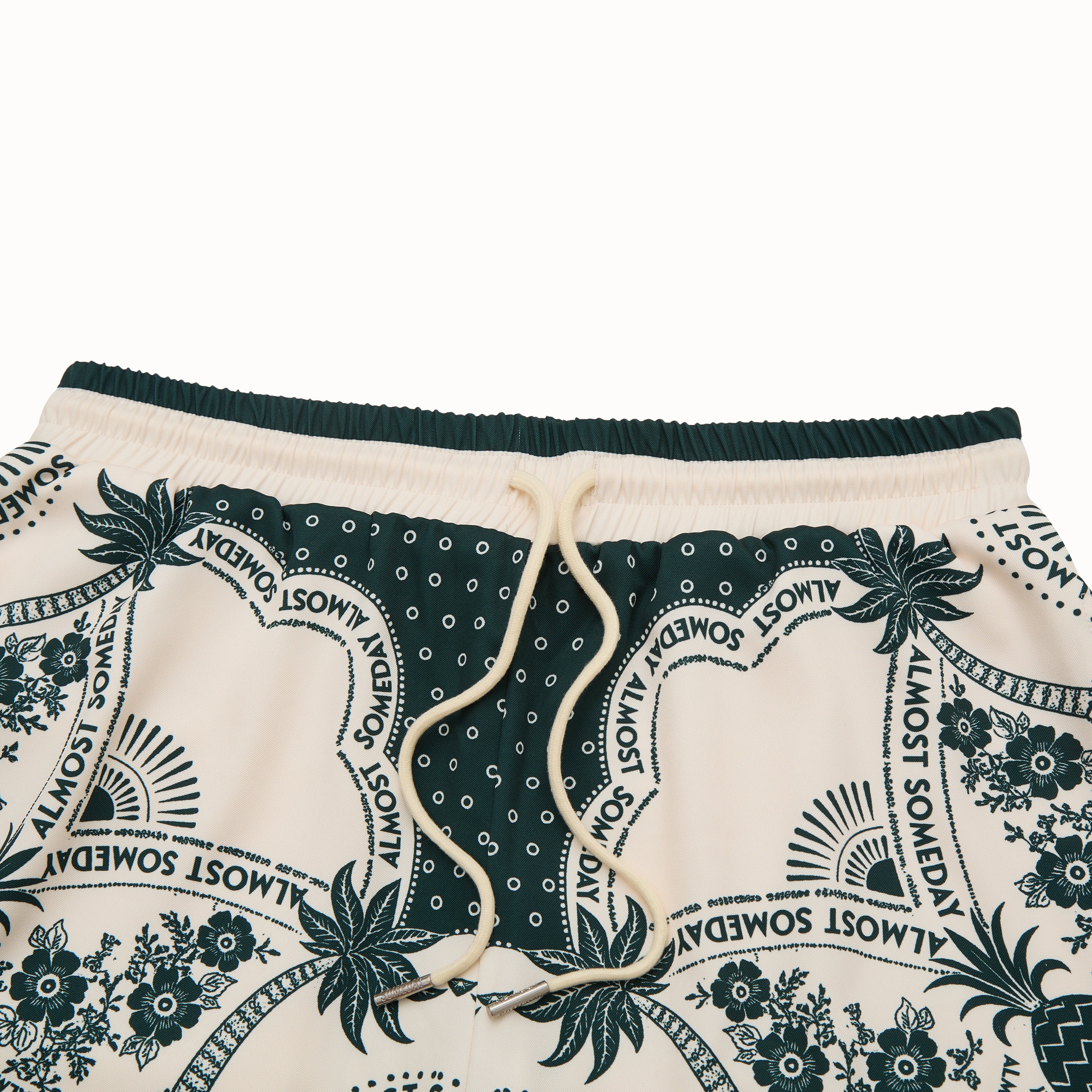 Pair of shorts with a floral and text pattern on a white background
