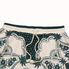 Pair of shorts with a floral and text pattern on a white background