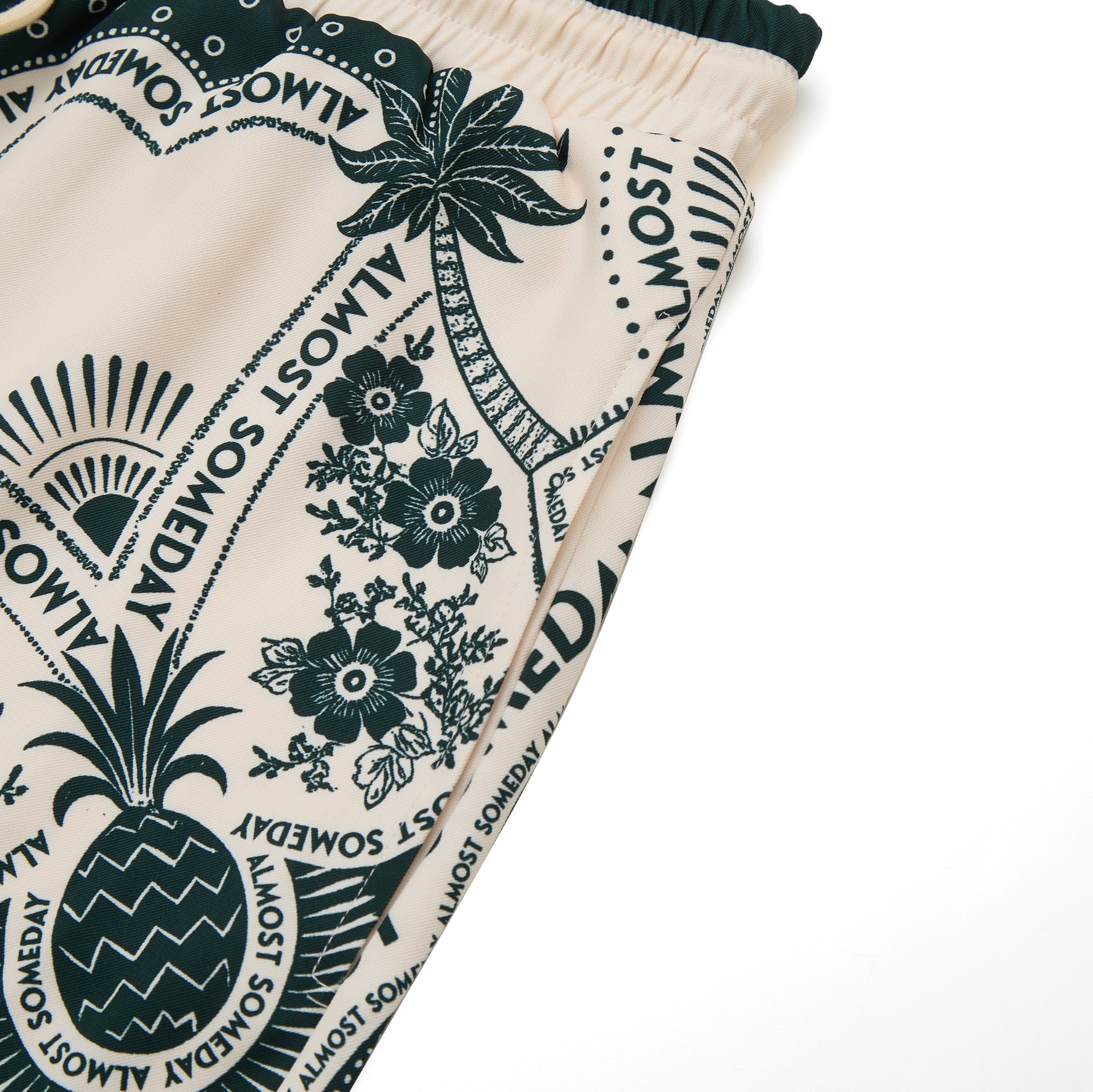 Close-up of a fabric with tropical patterns and text on a white background