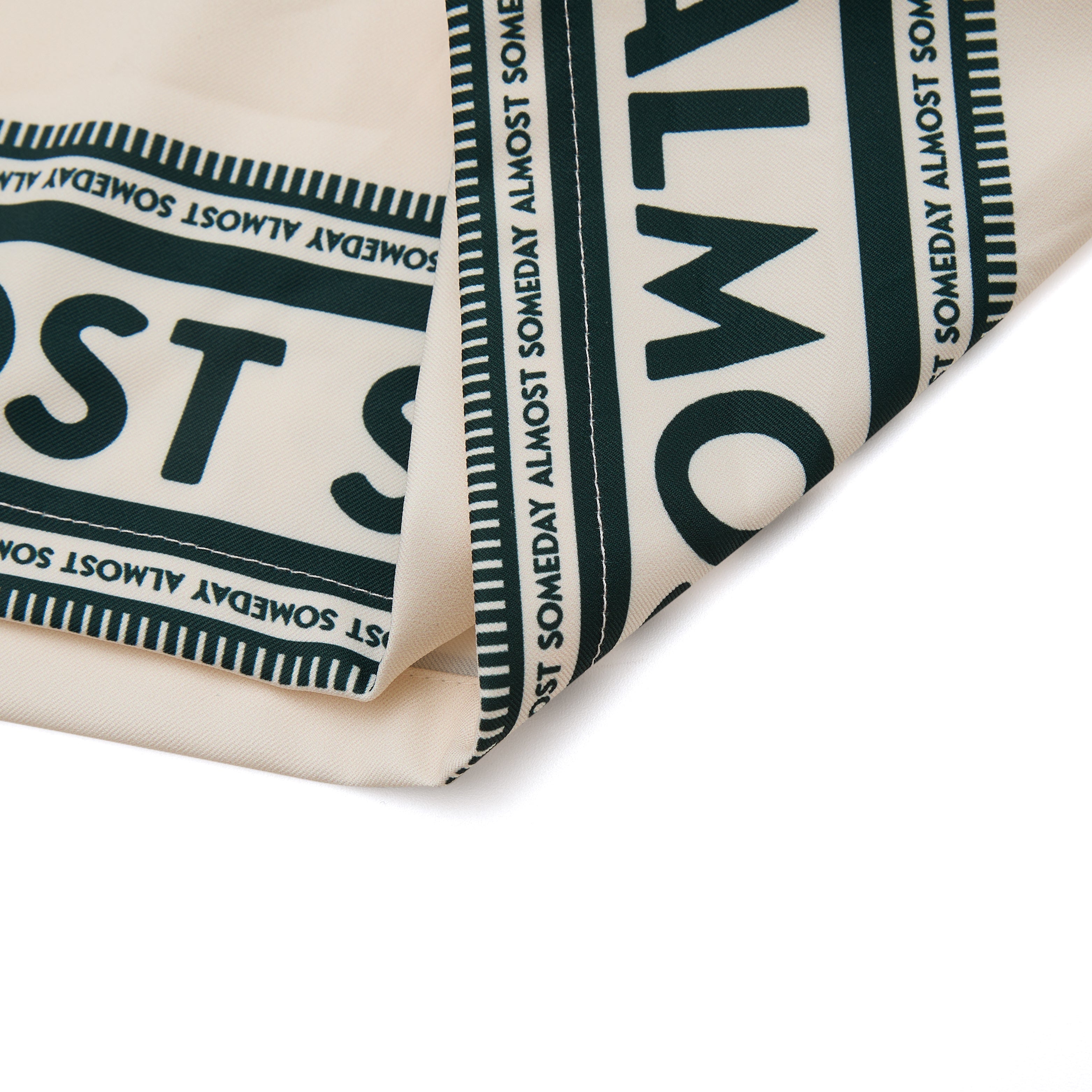 Close-up of a folded fabric with text pattern on a white background