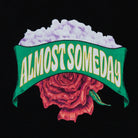 Design with 'ALMOST SOMEDAY' text over a red rose on a black background