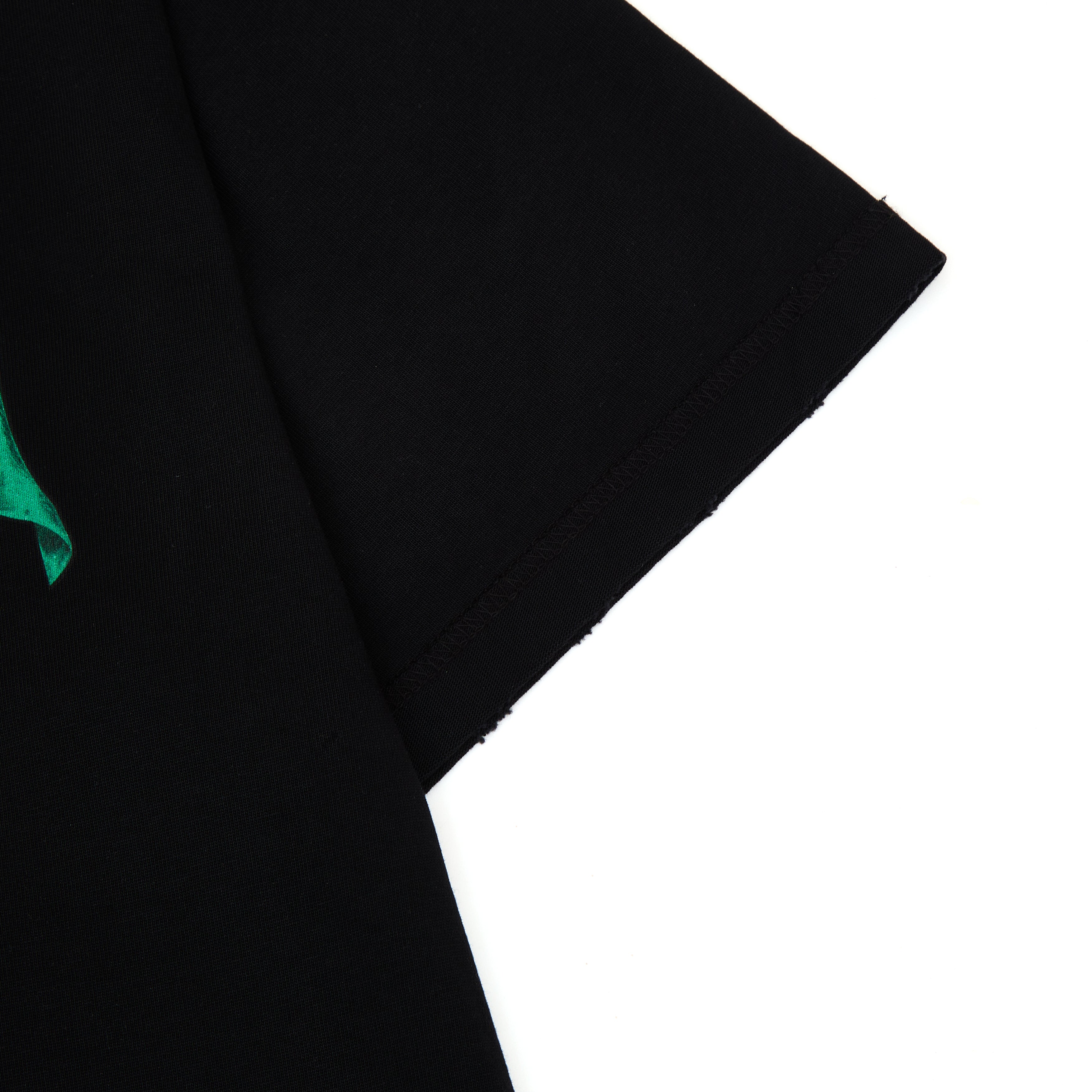 Black fabric with a green corner on a white background