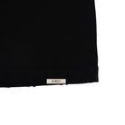 Close-up of a black fabric edge with a 'Almost' label on a white background
