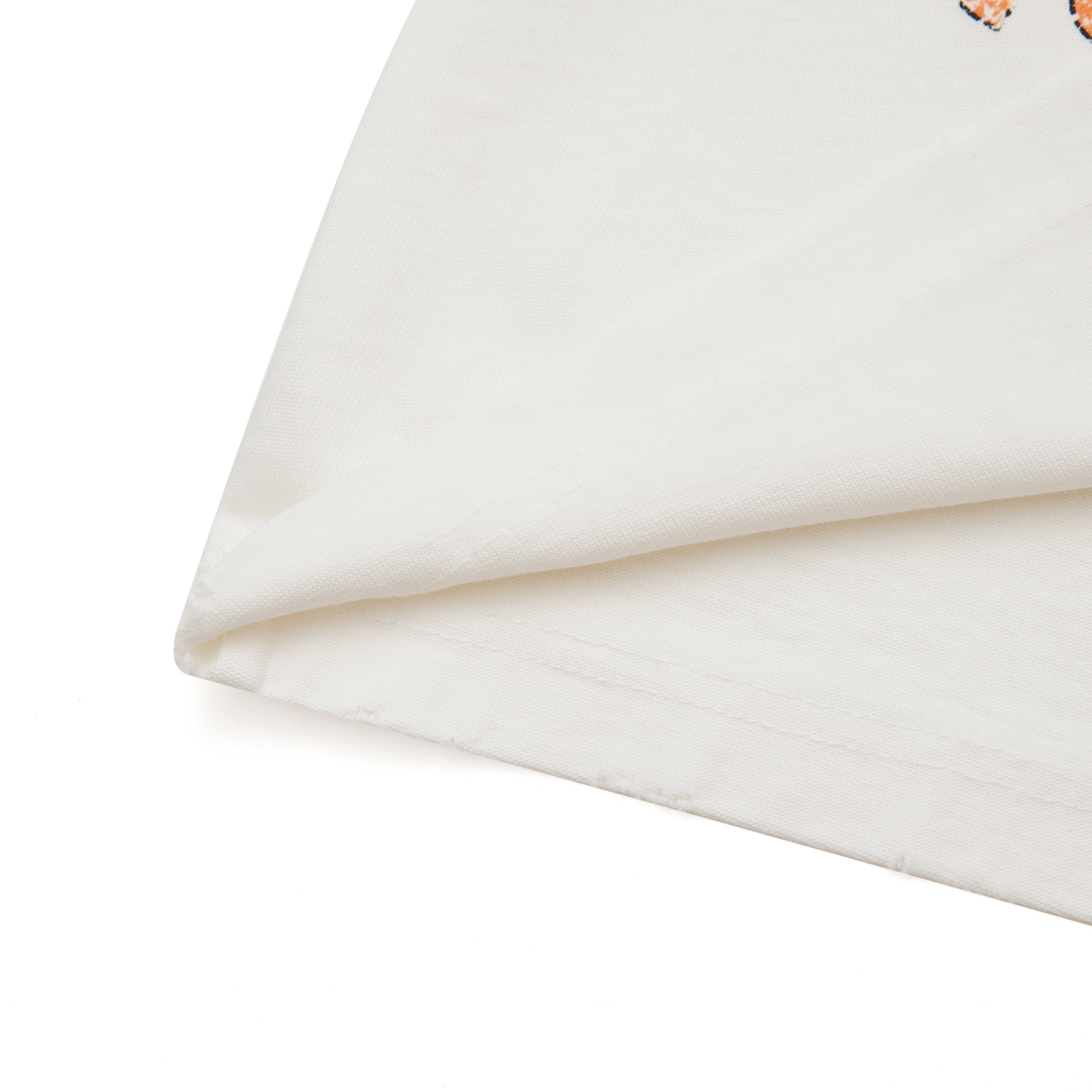 Close-up of a cream fabric with a subtle pattern on a white background