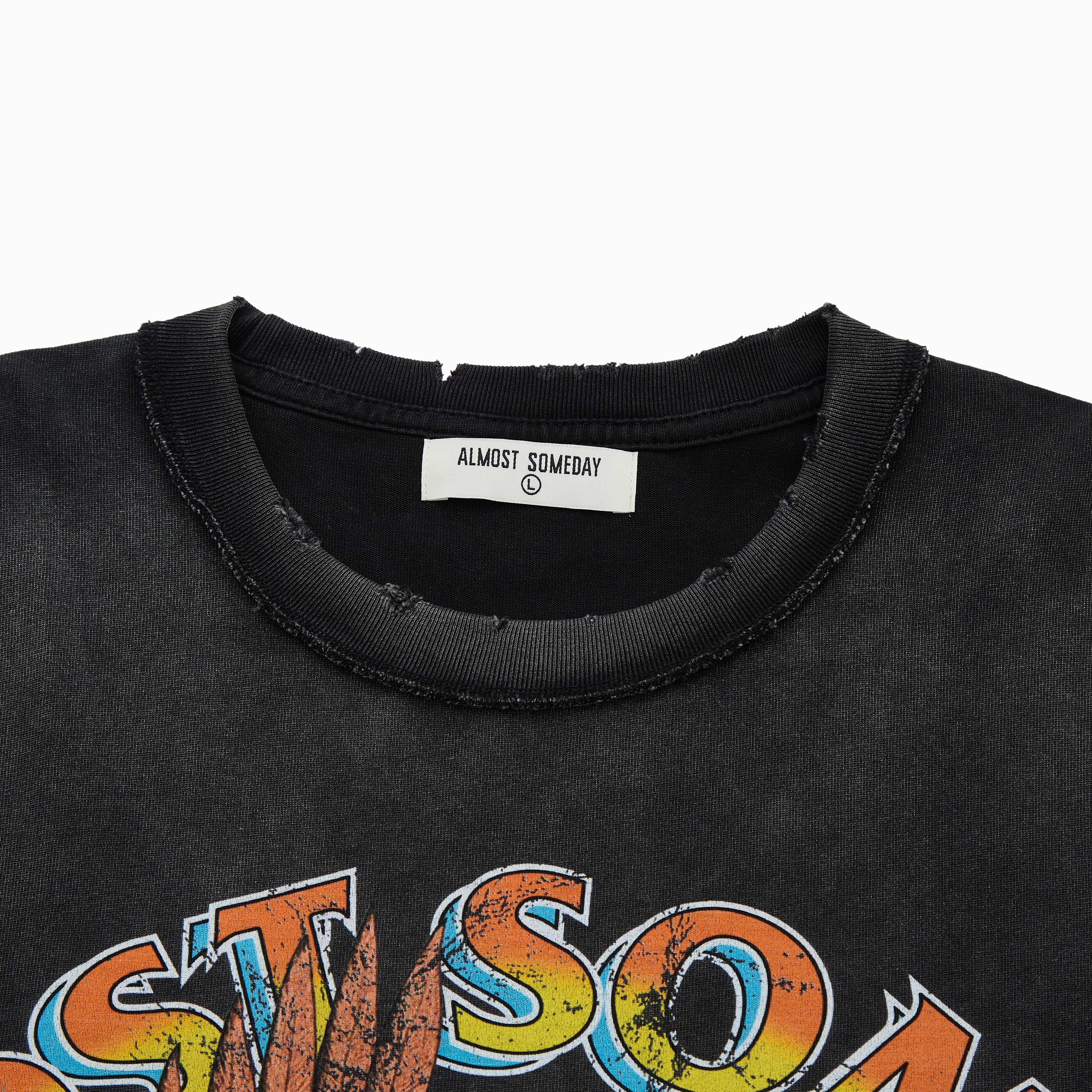 Black t-shirt with colorful text and 'Almost Someday' label on a white background