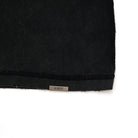 Black fabric with 'ALMOST' label on a white background