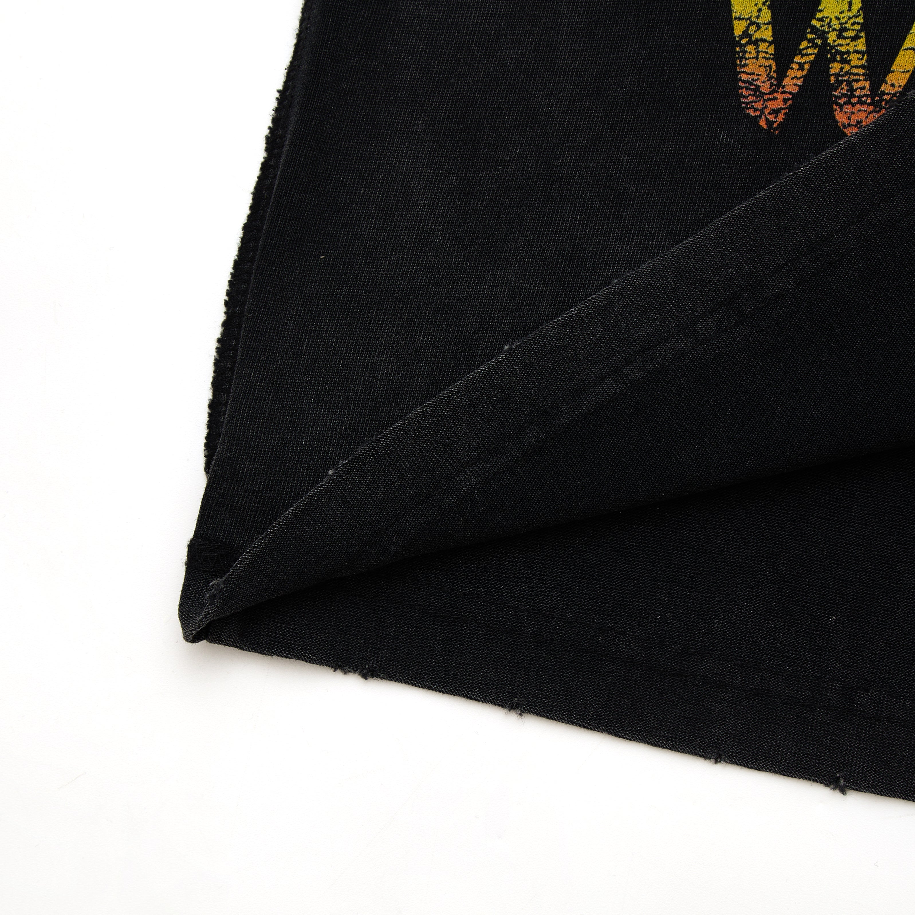 Black fabric with colorful pattern on a white background