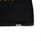 Black fabric with 'ALMOST' label on a white background