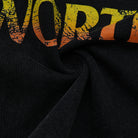 Black fabric with graphic close up printed in orange and yellow.