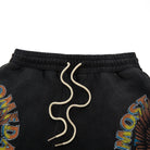 Black sweatshorts with colorful text and a snake-like drawstring on a white background