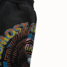 Black sweatshorts with colorful graphic design on a white background