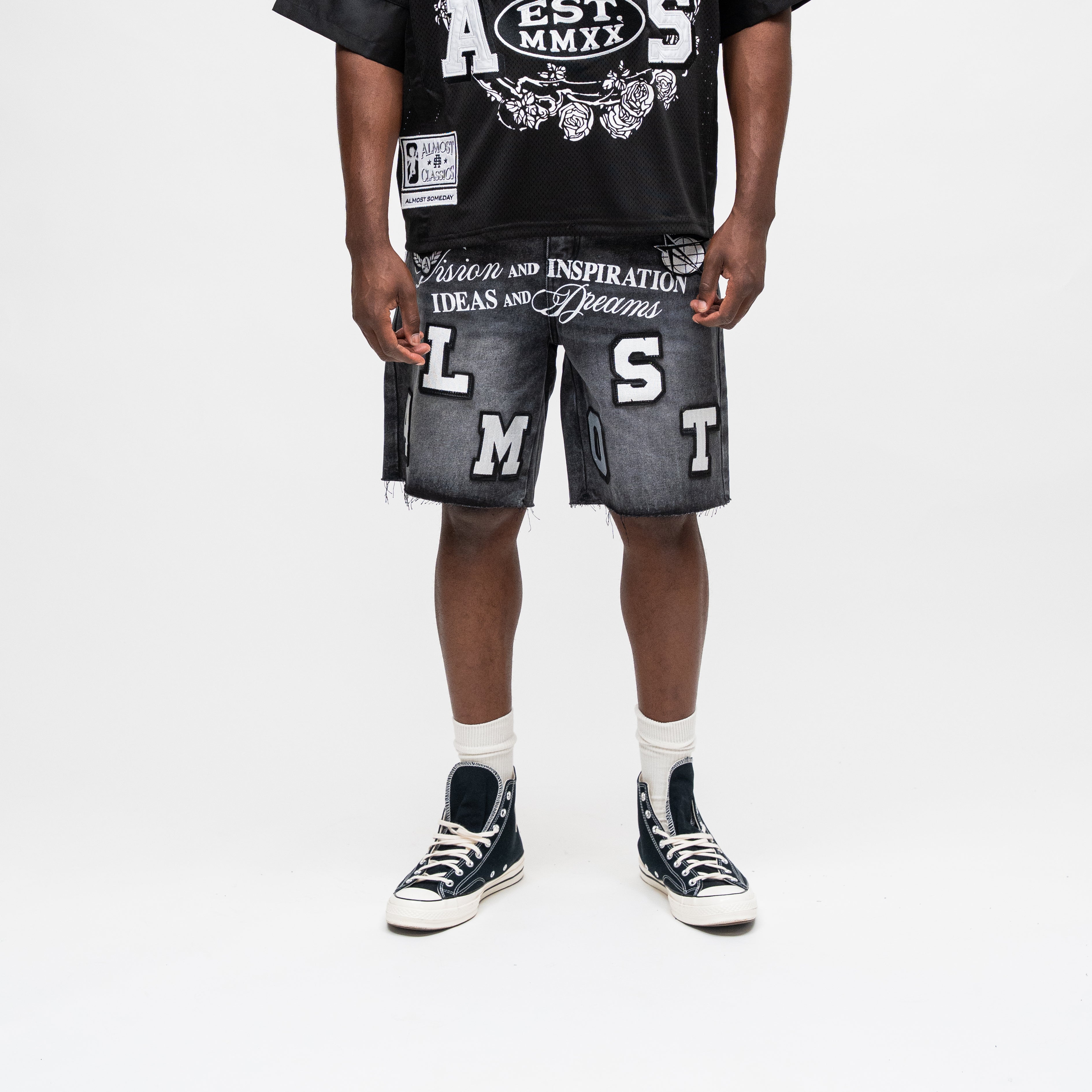 ALMOST SOMEDAY Letterman Denim Jort in Black, front view with oversized ALMOST block letter appliqué and Vision and Inspiration script waistband