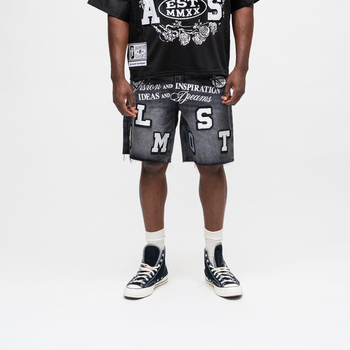 ALMOST SOMEDAY Letterman Denim Jort in Black, front view with oversized ALMOST block letter appliqué and Vision and Inspiration script waistband
