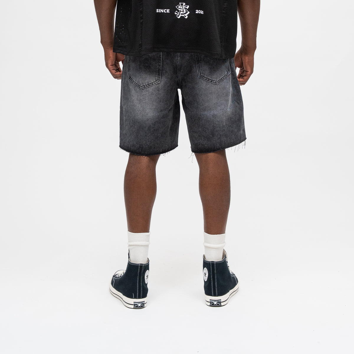 ALMOST SOMEDAY Letterman Denim Jort in Black, back view showing 5-pocket construction and subtle fade distressing