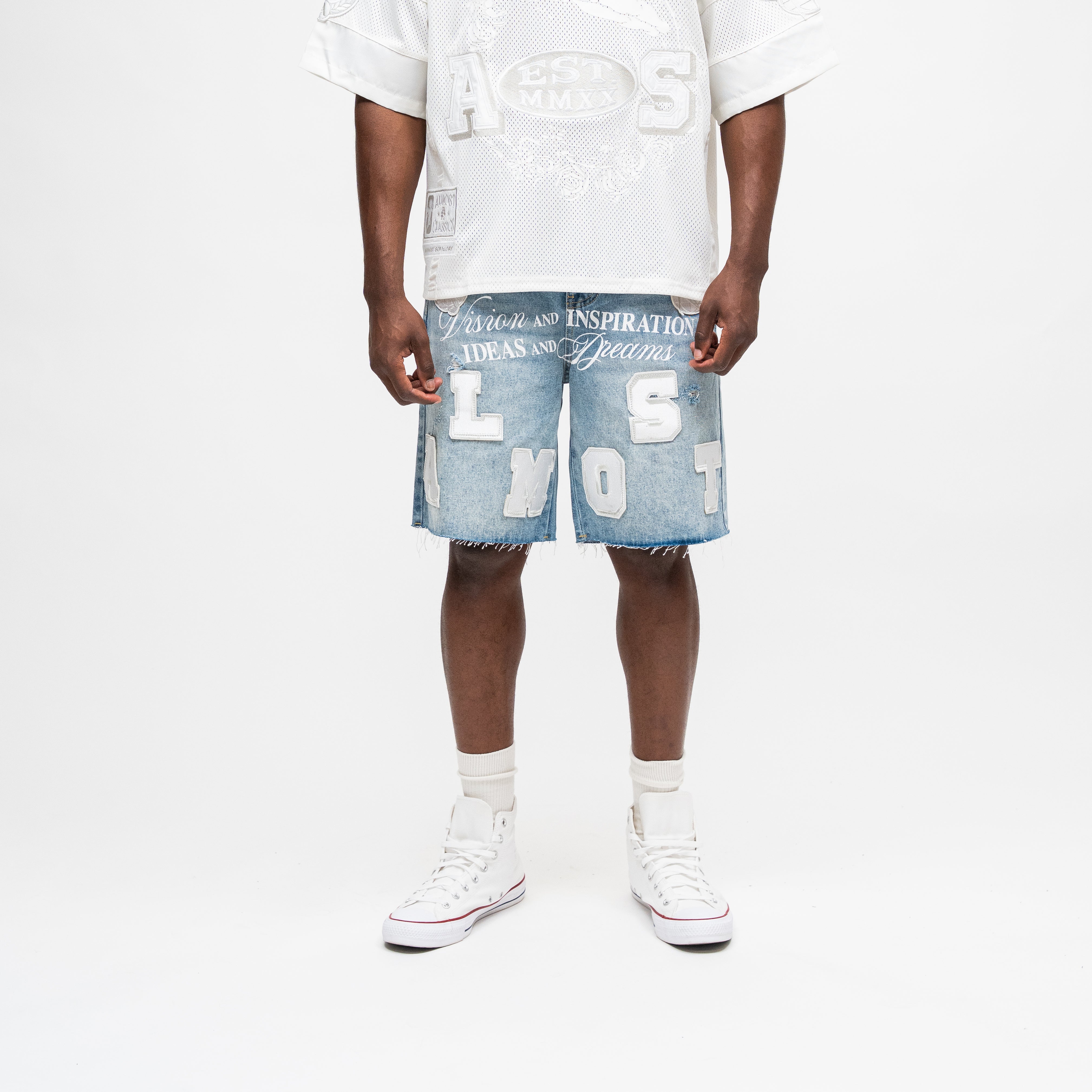 ALMOST SOMEDAY Letterman Denim Jort in Blue Wash, front view with oversized ALMOST block letter appliqué and Vision and Inspiration script waistband