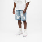 ALMOST SOMEDAY Letterman Denim Jort in Blue Wash, angled front view showing block letter appliqué detail and raw frayed hem
