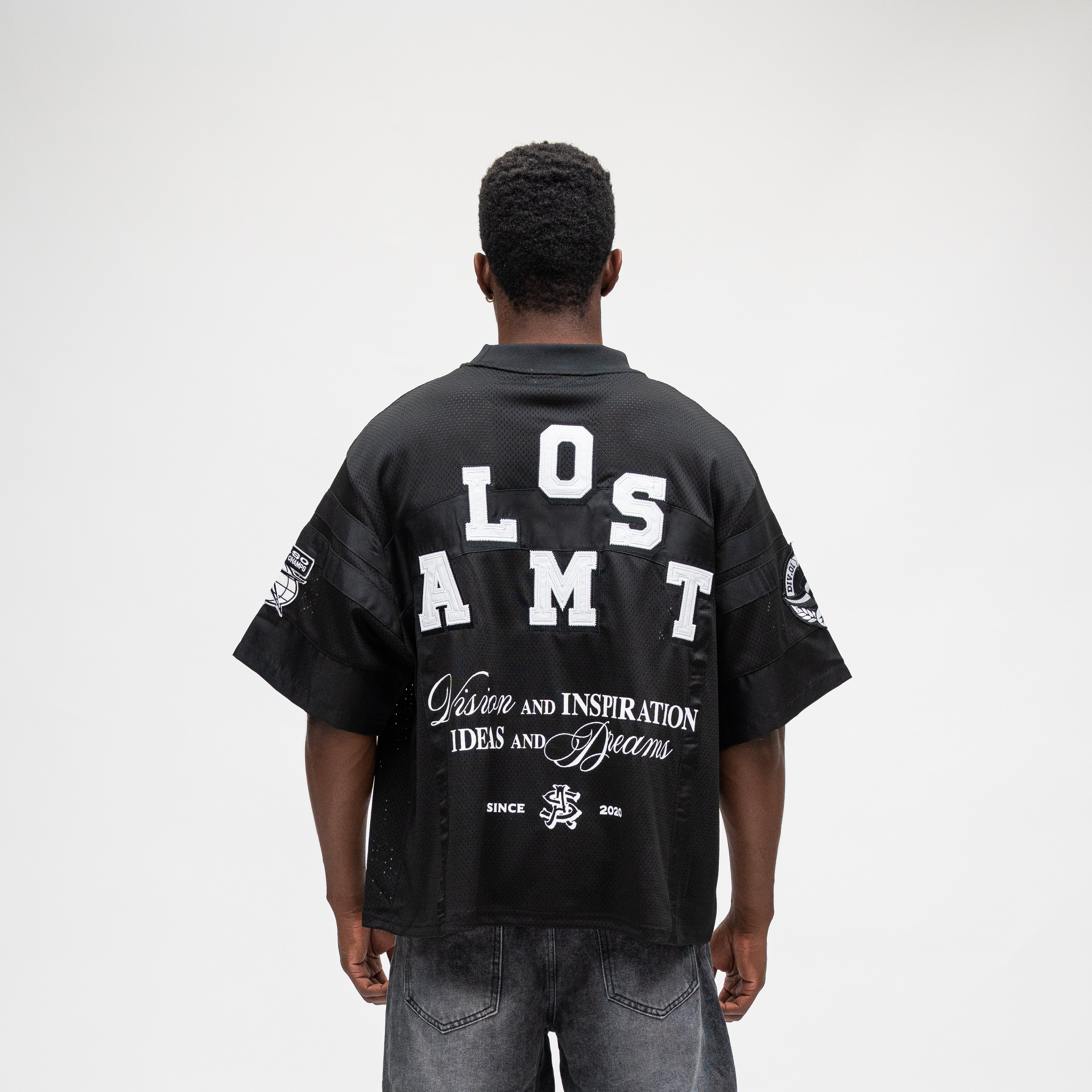ALMOST SOMEDAY Letterman Jersey Top in Black, back view with Almost block letter appliqué and Vision and Inspiration Ideas and Dreams script