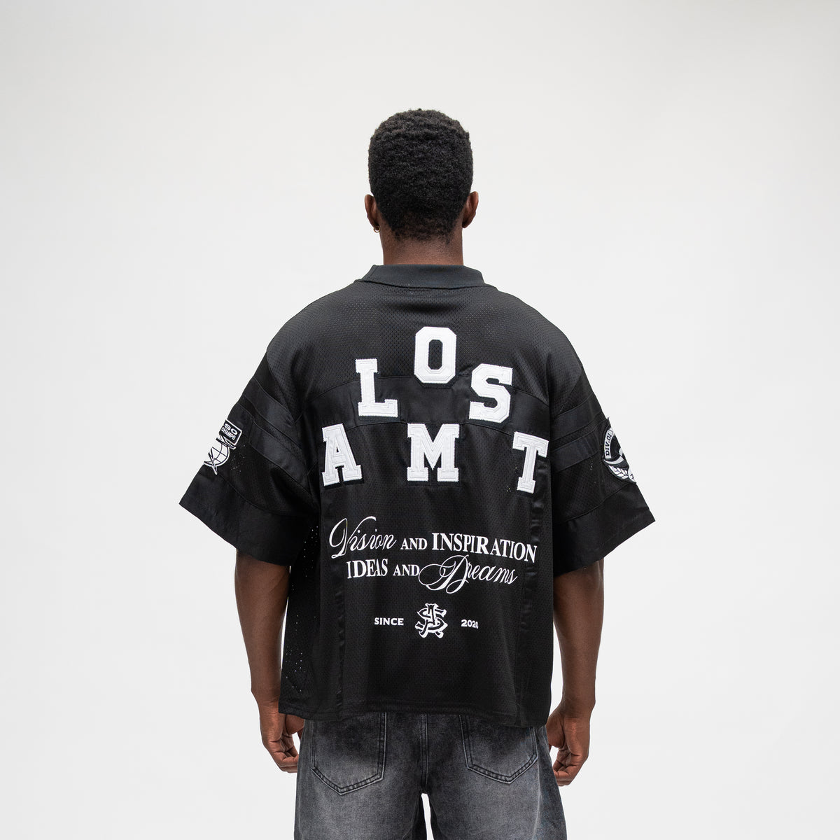 ALMOST SOMEDAY Letterman Jersey Top in Black, back view with Almost block letter appliqué and Vision and Inspiration Ideas and Dreams script