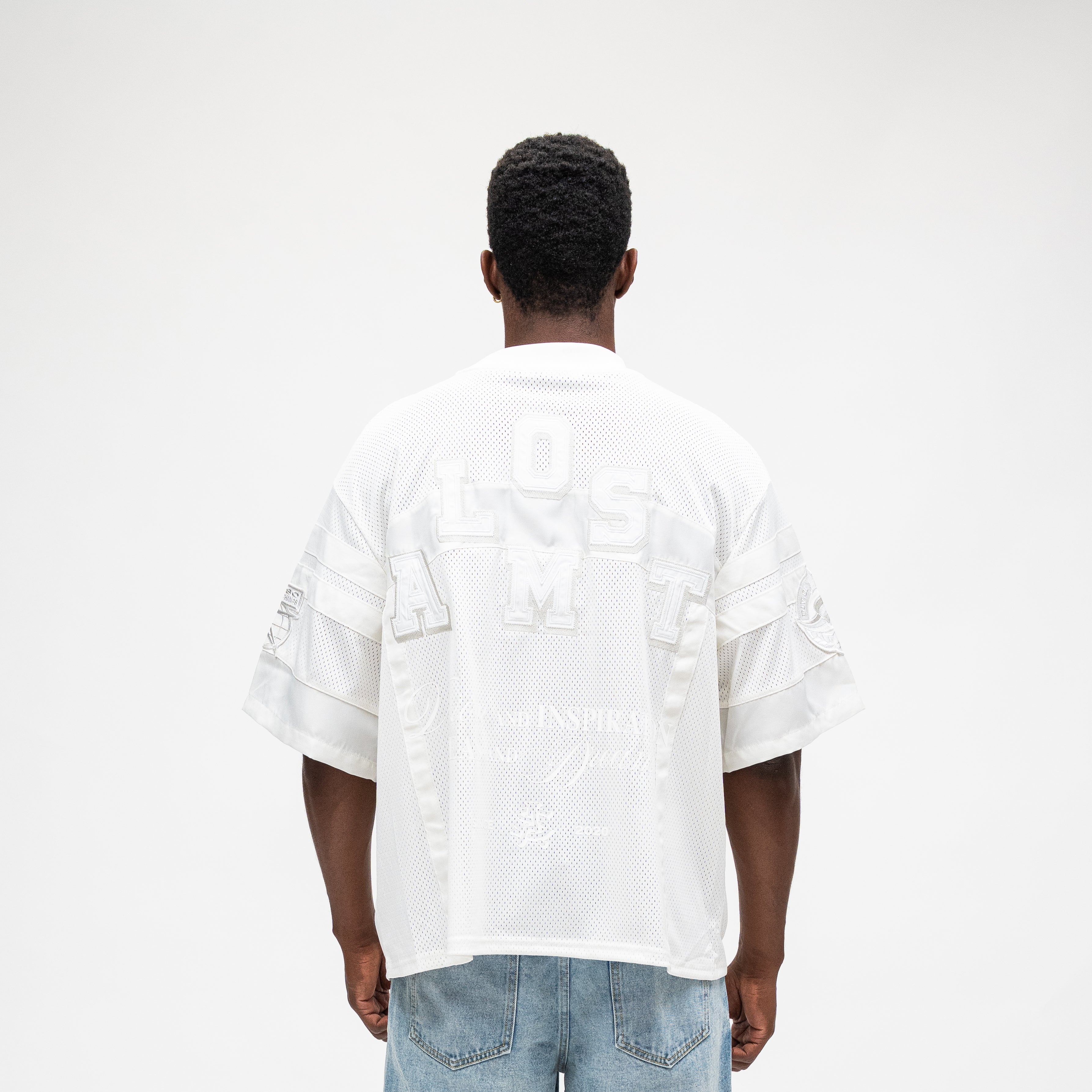 ALMOST SOMEDAY Letterman Jersey Top in Cream, back view with large tonal Almost Someday block letter appliqué across upper back