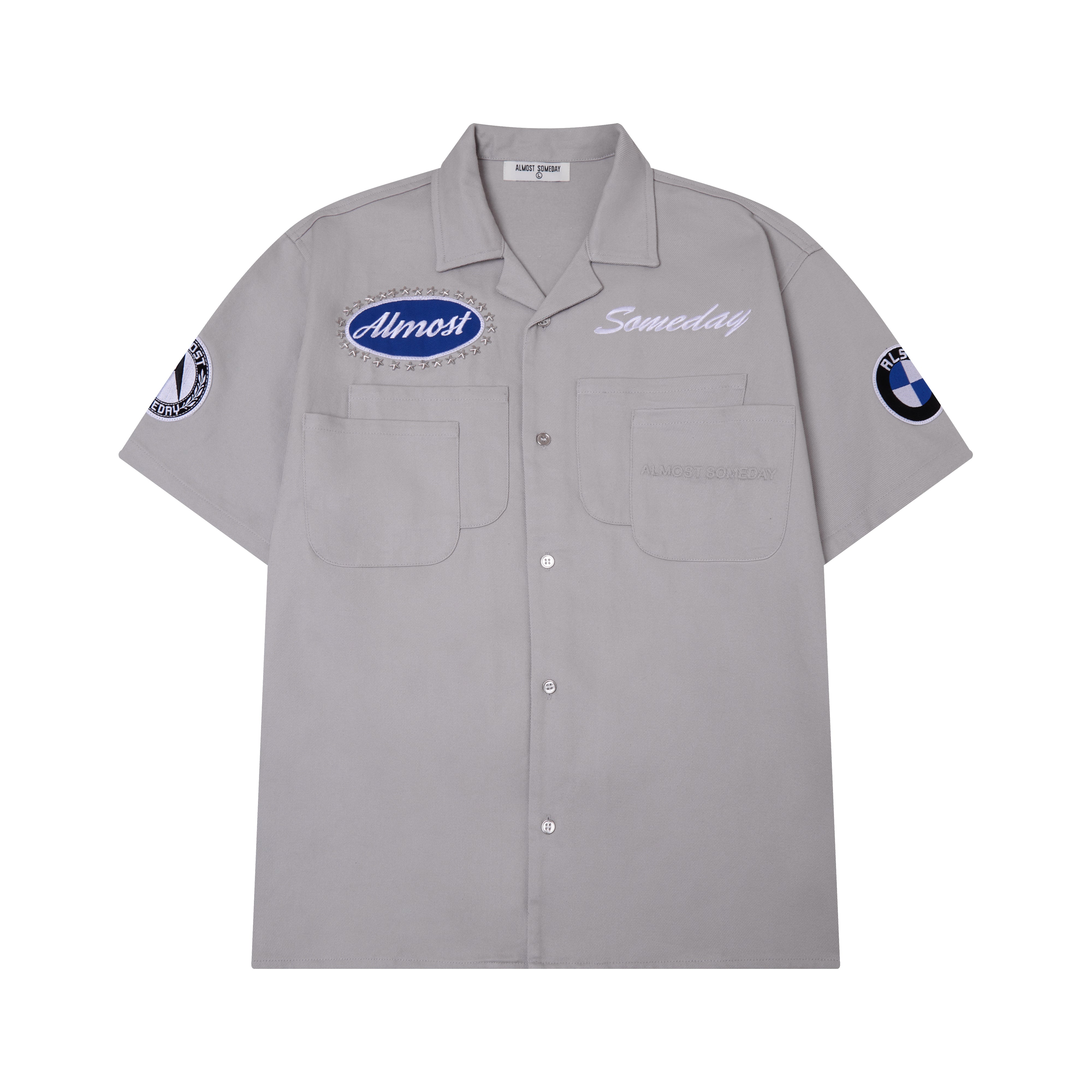 Gray short-sleeve shirt with embroidered ALMOST SOMEDAY patches and logos on a white background
