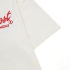 Cream t-shirt with red logo on a white background