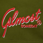 Red and white 'Almost Someday' logo on olive green fabric
