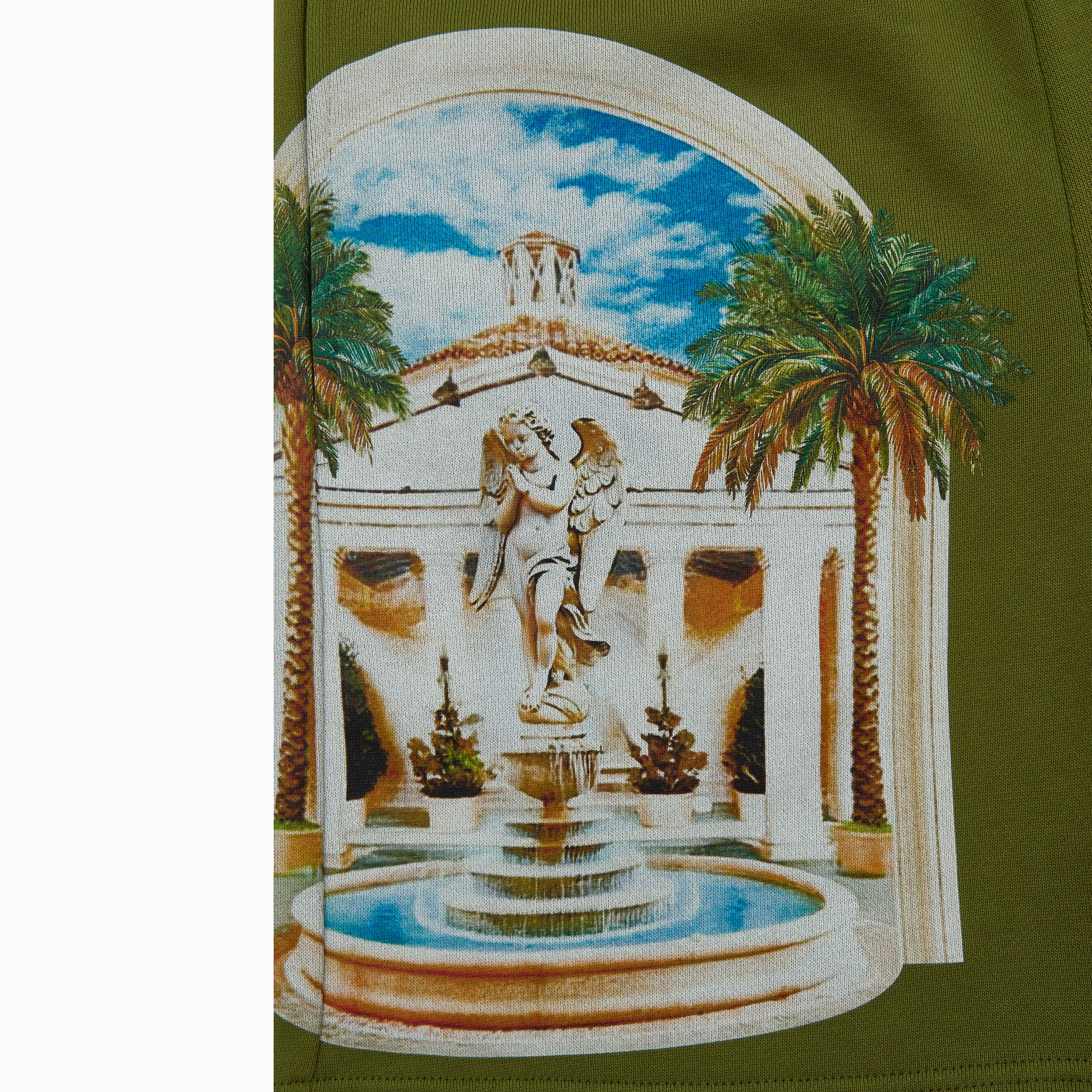 olive Green fabric with a printed design of a classical fountain and palm trees.