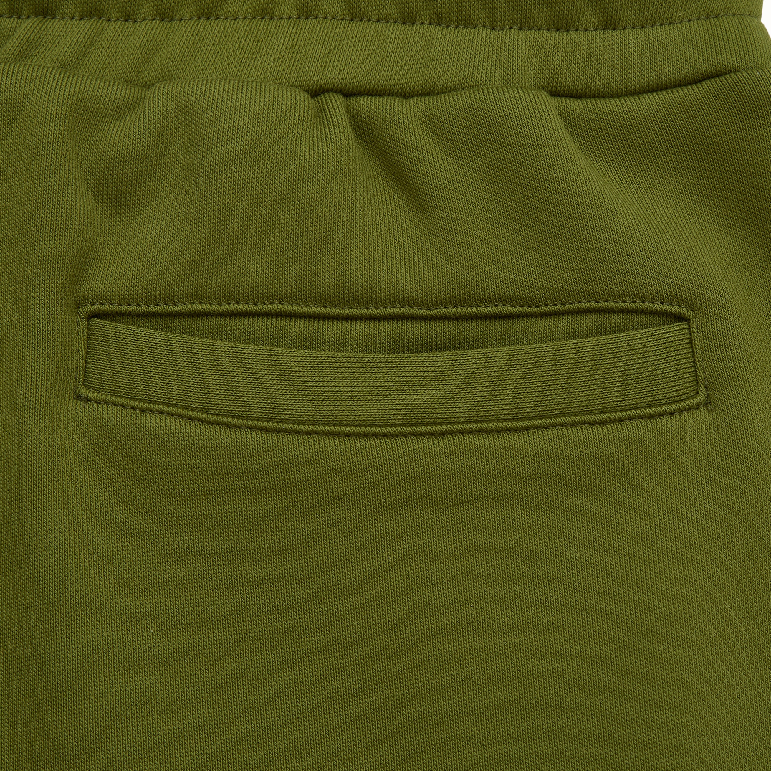 Close-up of green pants with a pocket