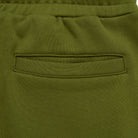 Close-up of green pants with a pocket